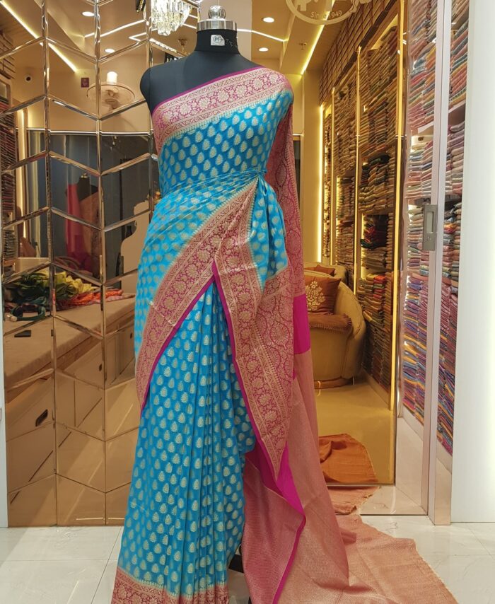 MOINI FABRICS - Banarasi Georgette Contrast Border Saree.
